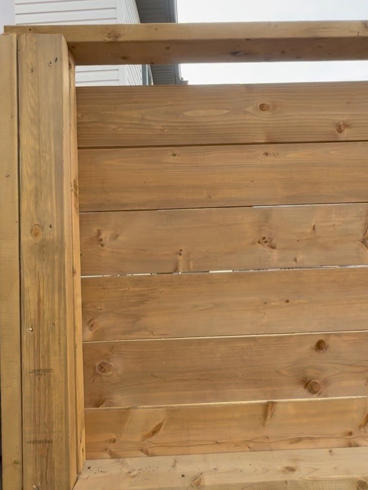Close-up of cedar boards and timber framing on a custom privacy screen